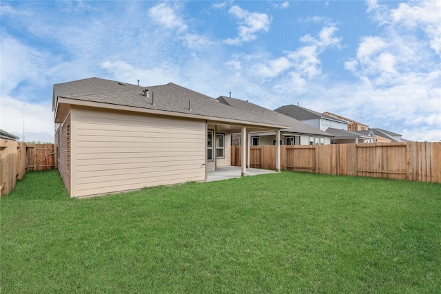 rear view of property with a patio and a lawn