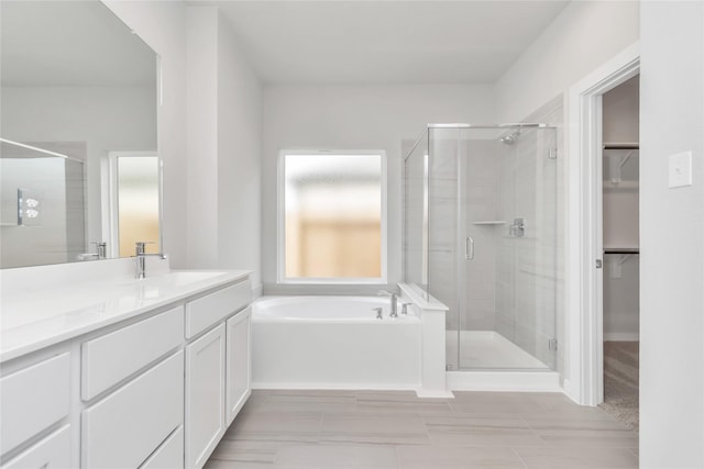 14707 Surfbird Ln, Houston, TX 77049 - bathroom with a shower stall, a spacious closet, a garden tub, and vanity