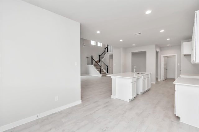 14707 Surfbird Ln, Houston, TX 77049 - kitchen featuring a sink, white cabinetry, recessed lighting, baseboards, and light countertops