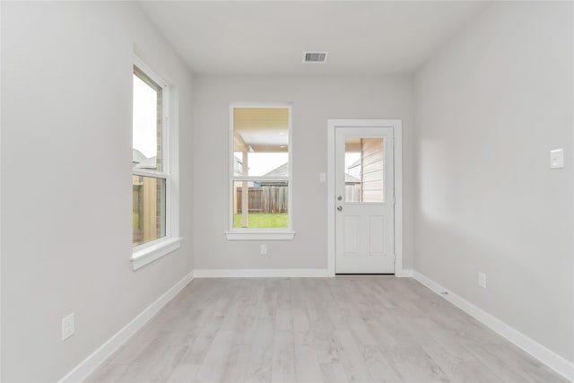 unfurnished room featuring light hardwood / wood-style floors