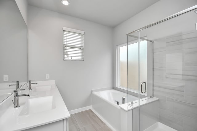 bathroom with vanity and independent shower and bath