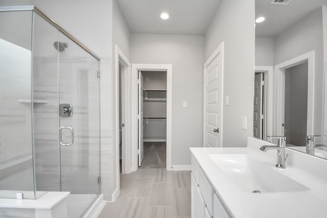 bathroom with vanity and an enclosed shower