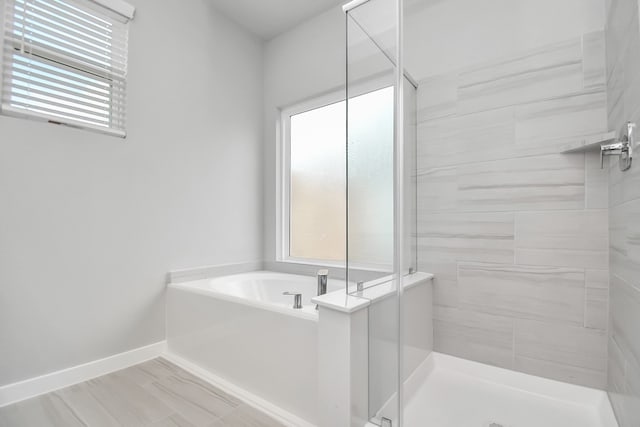 bathroom featuring separate shower and tub