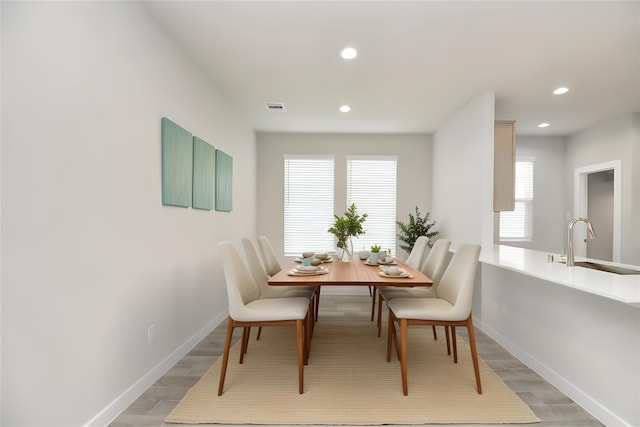 dining room featuring hardwood / wood-style floors and sink