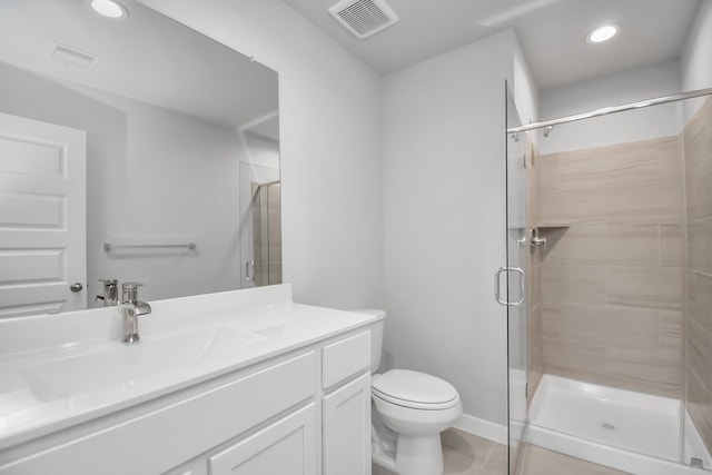 bathroom featuring vanity, tile patterned floors, toilet, and an enclosed shower