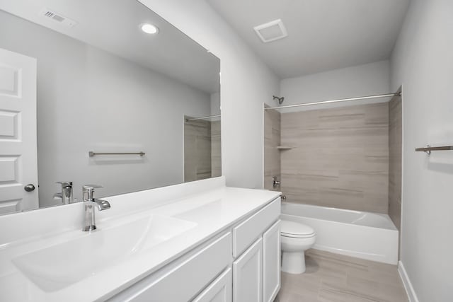 full bathroom with vanity, toilet, and tiled shower / bath combo