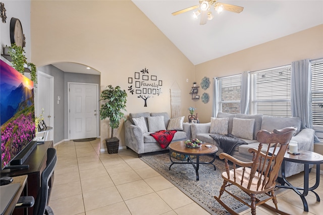 living room featuring ceiling fan, high vaulted ceiling, and light tile patterned floors