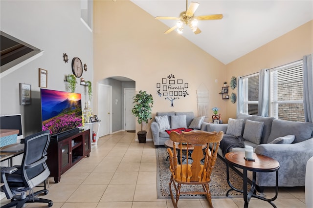 tiled living room with high vaulted ceiling and ceiling fan