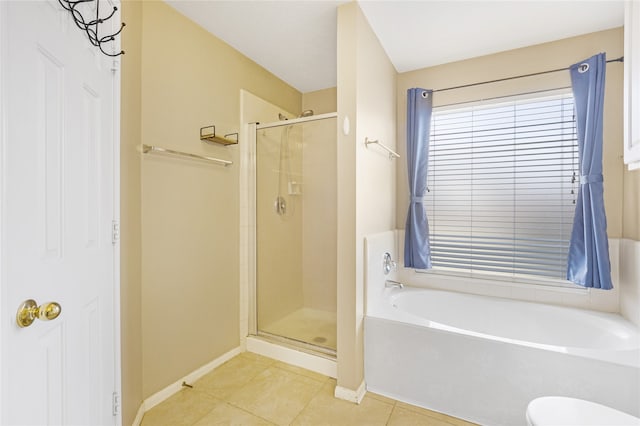 bathroom with toilet, shower with separate bathtub, and tile patterned flooring