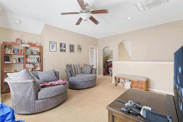 carpeted living room with ceiling fan