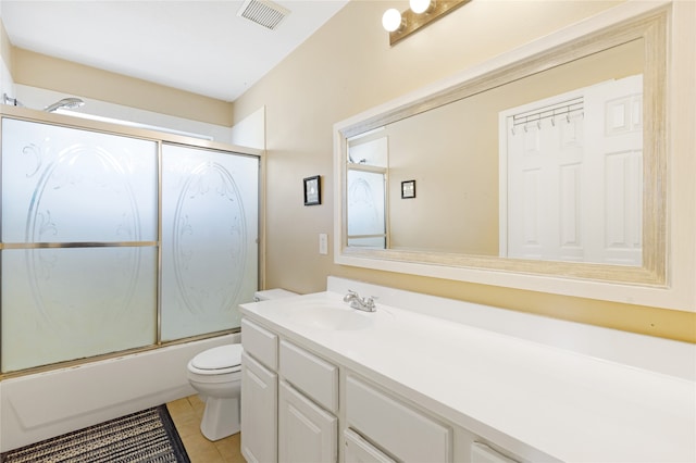 full bathroom with toilet, combined bath / shower with glass door, vanity, and tile patterned flooring