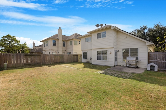 rear view of property with a patio and a lawn