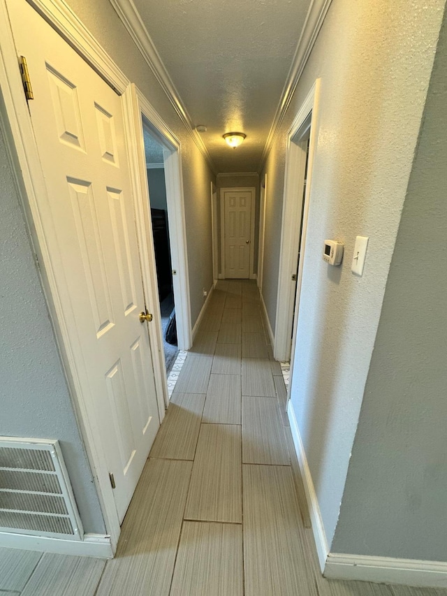 8609 Lynwood Ln, Port Arthur, TX 77642 - corridor featuring visible vents, ornamental molding, baseboards, and wood tiled floor