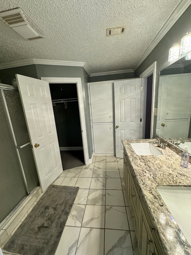 bathroom with vanity, ornamental molding, walk in shower, and a textured ceiling