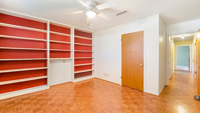 unfurnished bedroom featuring parquet flooring and ceiling fan