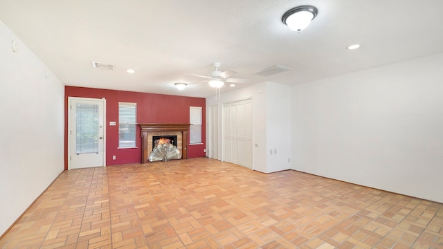 unfurnished living room with light parquet flooring and ceiling fan