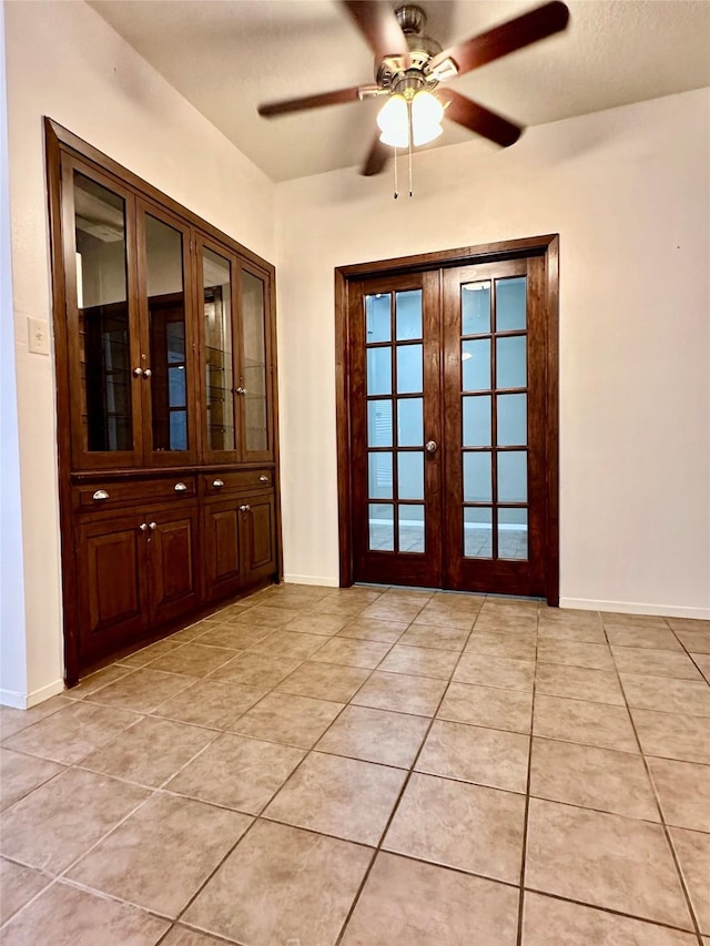 7029 N Holiday Dr, Galveston, TX 77550 - doorway to outside with light tile patterned floors, a ceiling fan, and baseboards