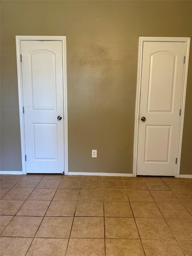 7029 N Holiday Dr, Galveston, TX 77550 - empty room featuring light tile patterned flooring and baseboards