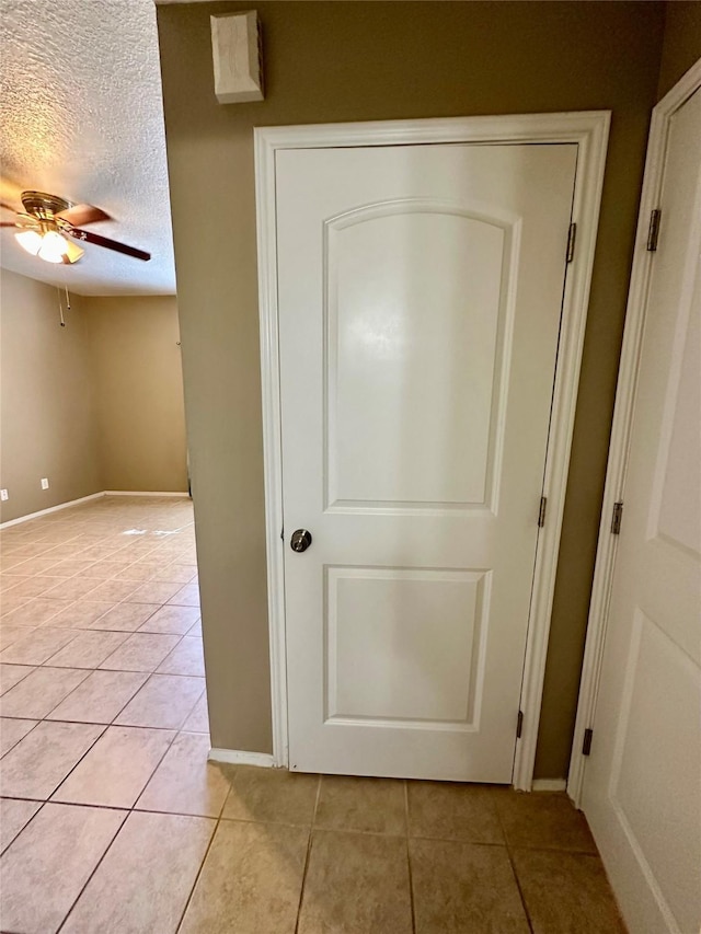 7029 N Holiday Dr, Galveston, TX 77550 - details with a textured ceiling, a ceiling fan, and baseboards