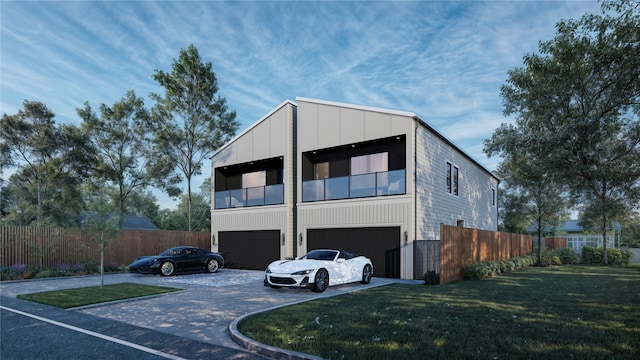 view of front of home with a garage, driveway, fence, board and batten siding, and a front yard