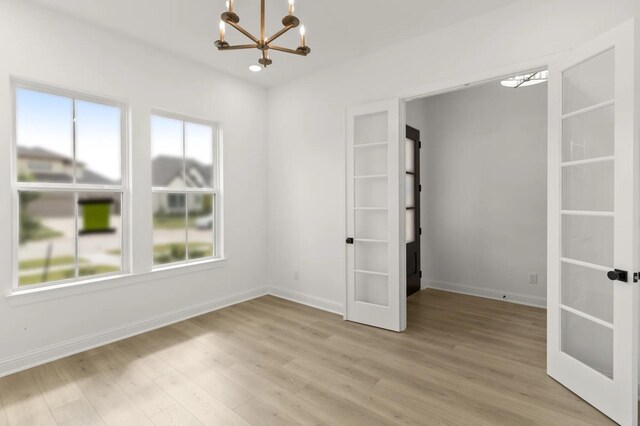 4622 Sycamore Way Rd, Fulshear, TX 77441 - unfurnished bedroom featuring a chandelier, french doors, multiple windows, and light wood finished floors