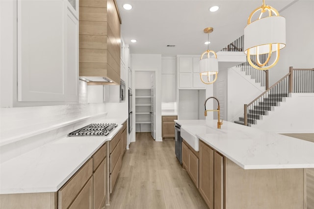 4622 Sycamore Way Rd, Fulshear, TX 77441 - kitchen with appliances with stainless steel finishes, light wood-type flooring, recessed lighting, pendant lighting, and an island with sink