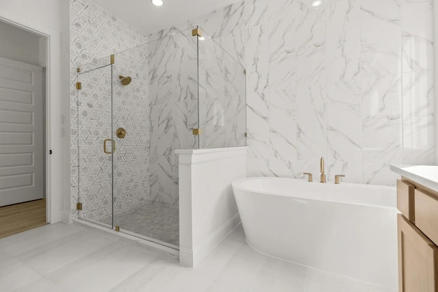 4622 Sycamore Way Rd, Fulshear, TX 77441 - full bath with tile walls, a freestanding bath, a marble finish shower, and vanity