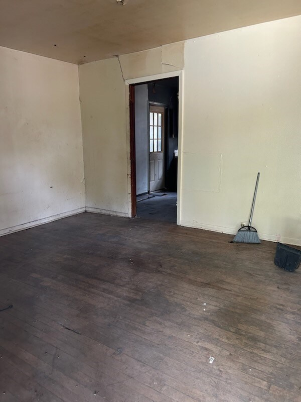 spare room with dark hardwood / wood-style floors