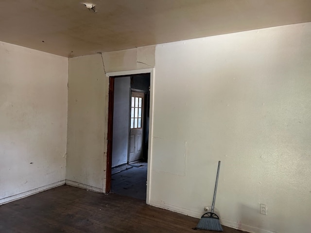 empty room with dark wood-type flooring