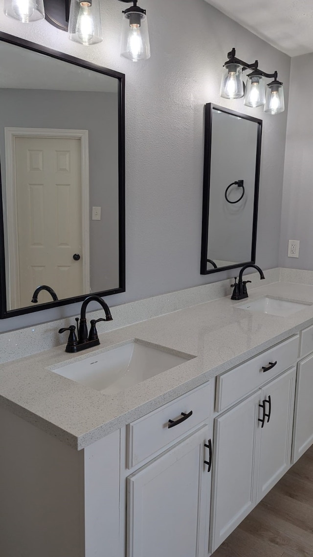 bathroom featuring vanity and wood-type flooring