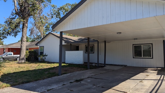 view of side of home with a lawn and a carport