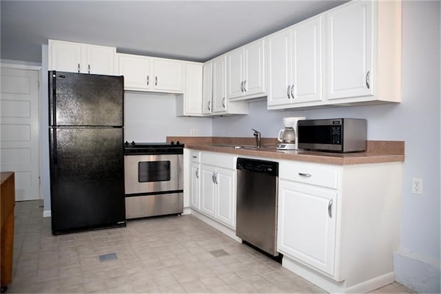 kitchen with white cabinetry, sink, and stainless steel appliances