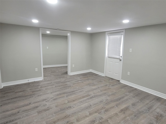 basement with light hardwood / wood-style flooring