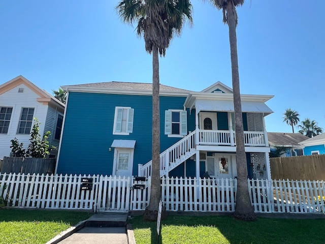 view of front of house with a porch and a front yard