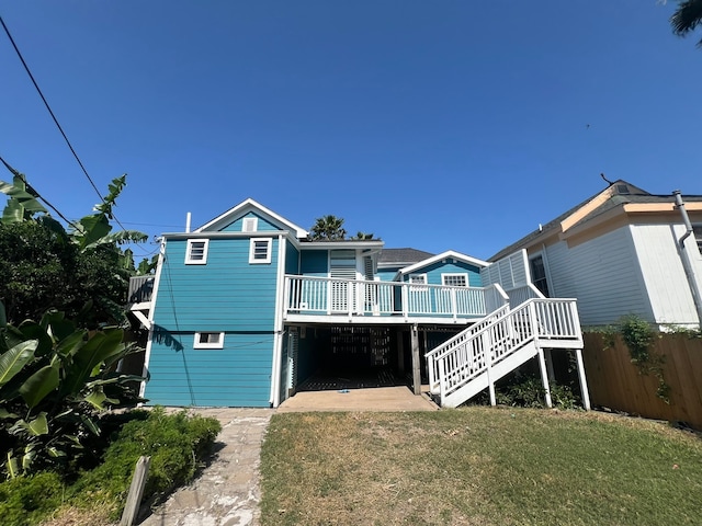 back of property featuring a yard and a deck