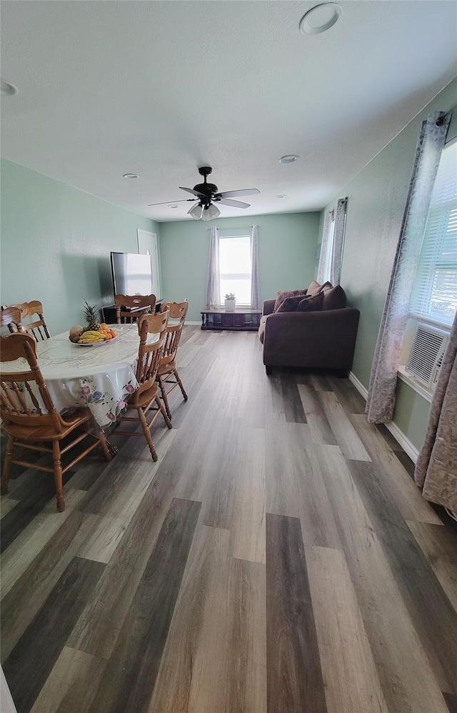 interior space featuring cooling unit, hardwood / wood-style flooring, and ceiling fan