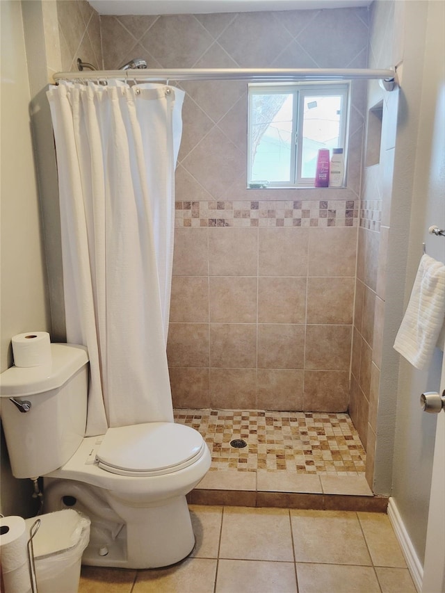 bathroom with toilet, tile patterned floors, and a shower with curtain