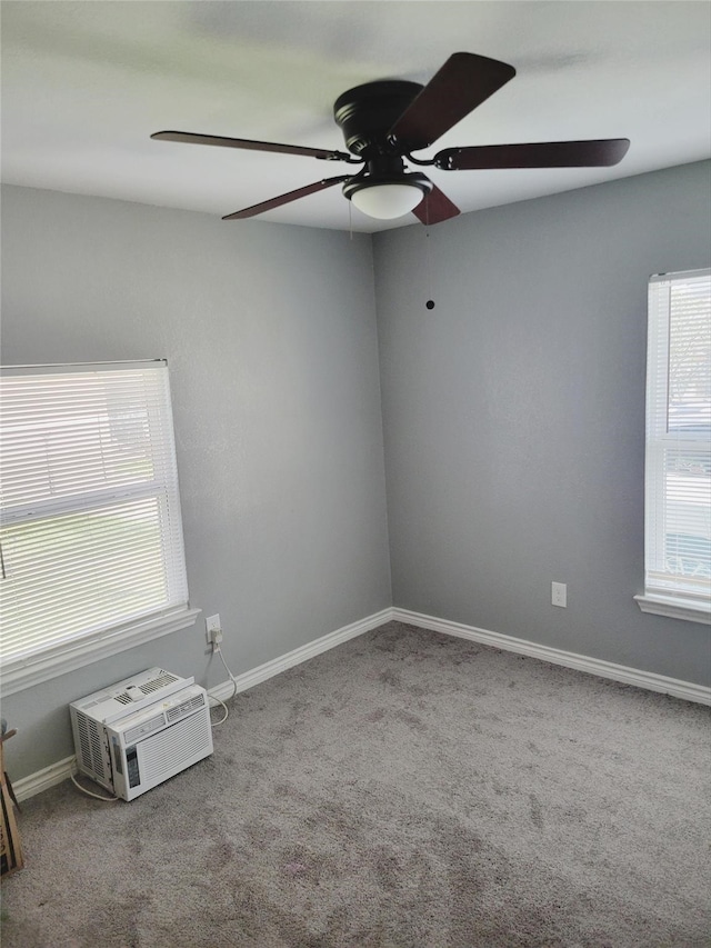 carpeted spare room featuring ceiling fan and a wall unit AC