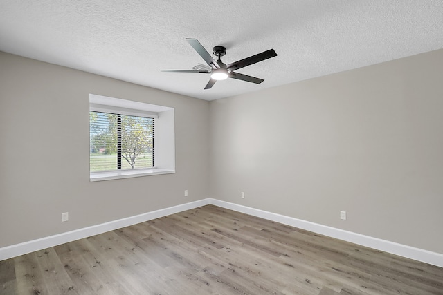 unfurnished room featuring light hardwood / wood-style floors, ceiling fan, and a textured ceiling