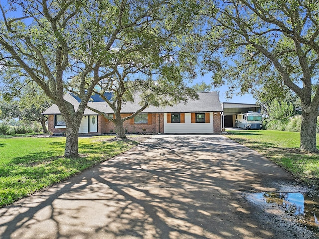 ranch-style house featuring a front lawn and a carport