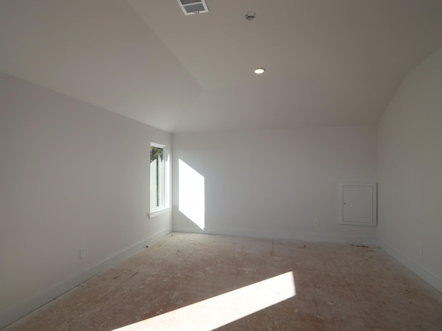 spare room featuring lofted ceiling