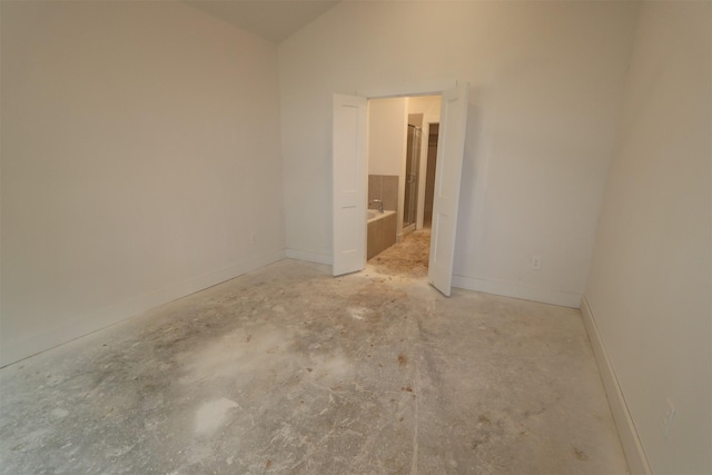 spare room featuring lofted ceiling