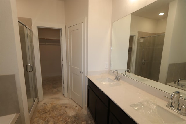 bathroom featuring vanity and a shower with shower door