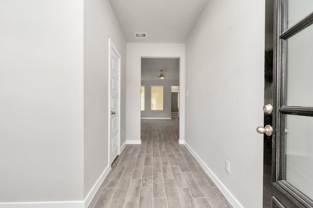 corridor with light hardwood / wood-style flooring