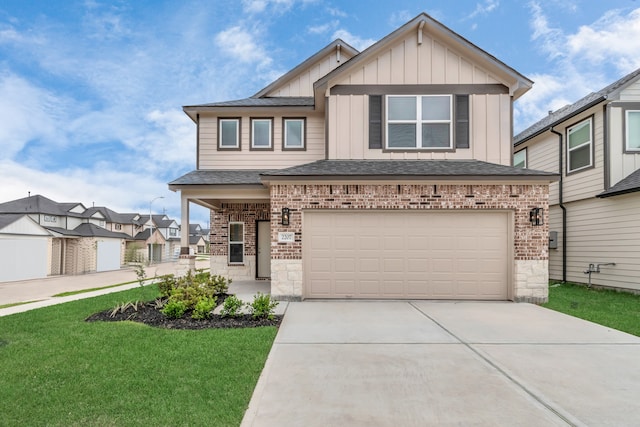 view of front of property featuring a front yard and a garage