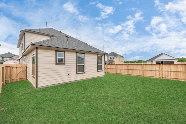 rear view of house with a yard