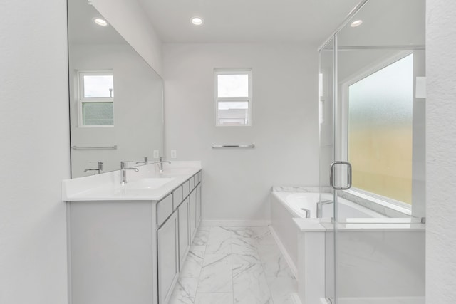 bathroom with vanity, a healthy amount of sunlight, and plus walk in shower