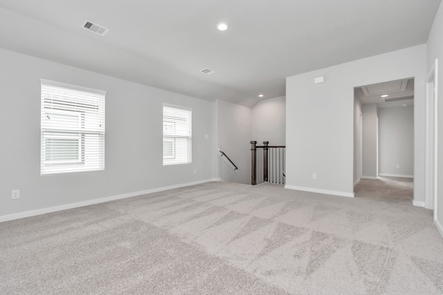 unfurnished room featuring light carpet