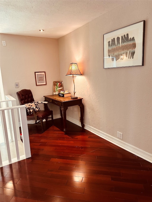 hall featuring a textured ceiling and dark hardwood / wood-style flooring