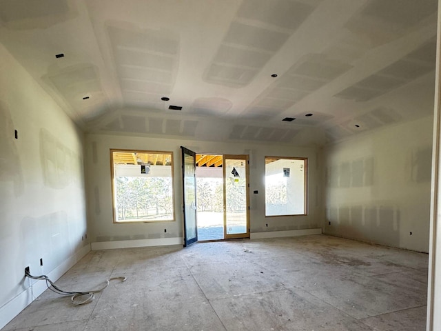 spare room featuring lofted ceiling